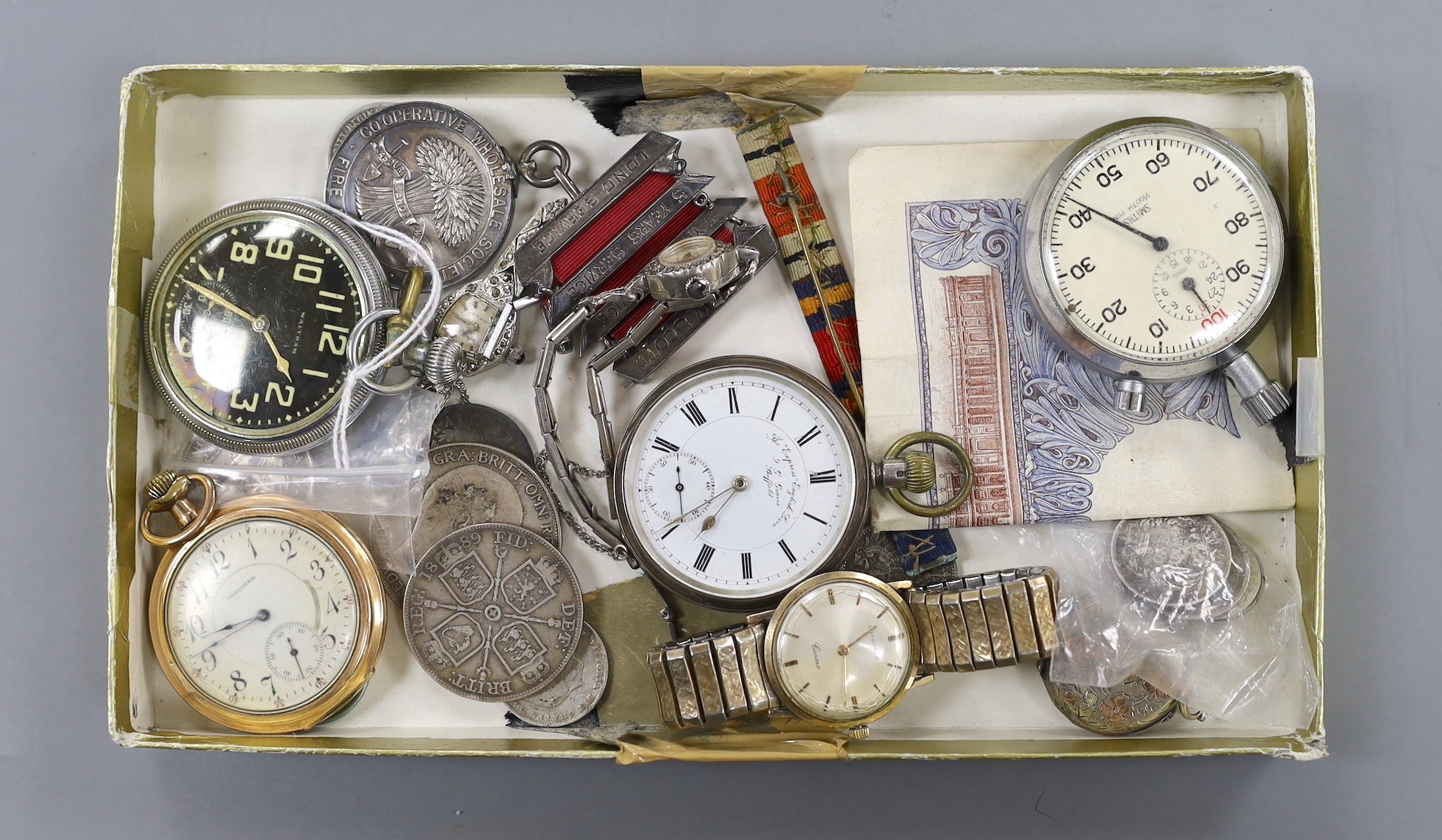 Two Waltham pocket watches including black dial military, a stopwatch, Longines Cosmo gold plated watch, lady's watch minor coins and a Fire Brigade medal.